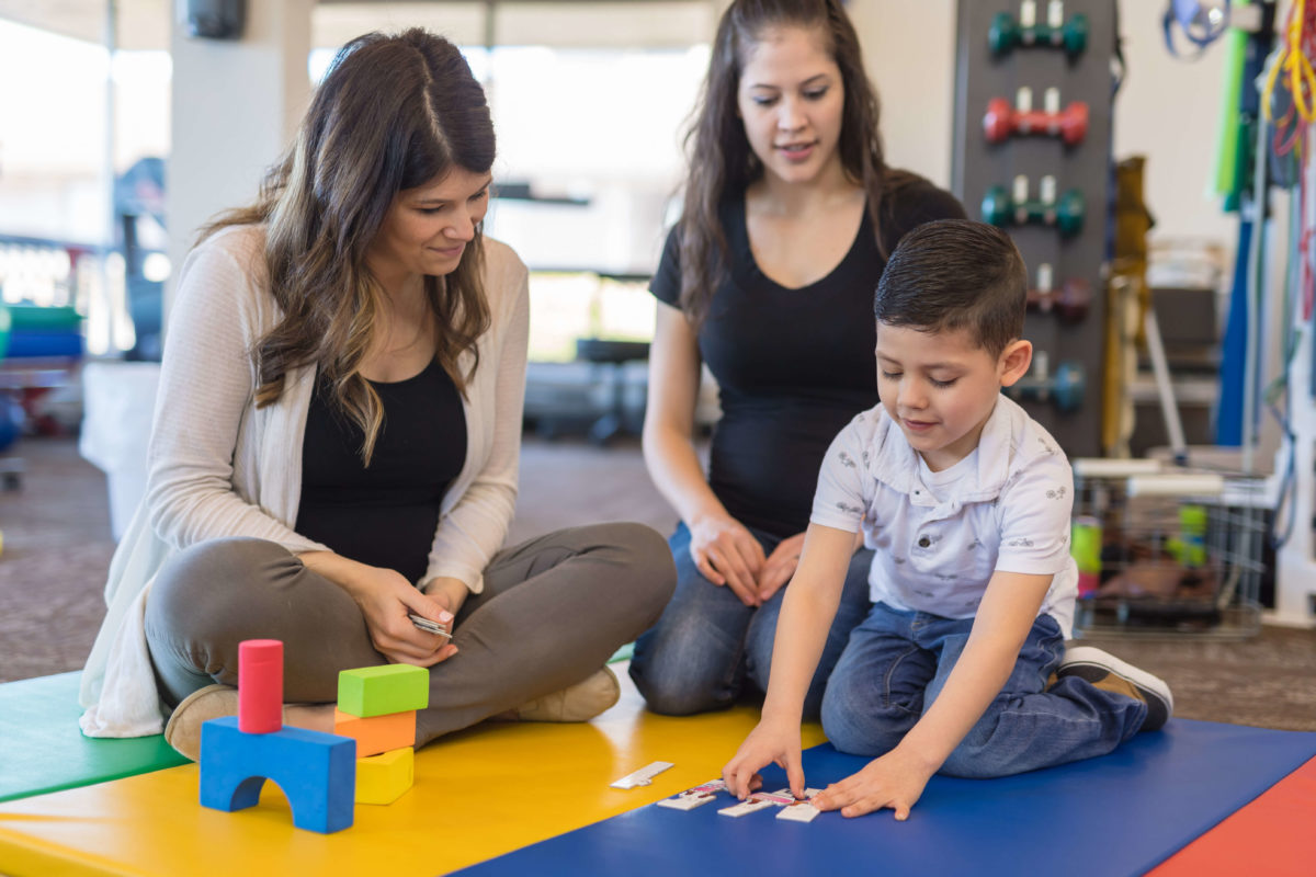 A speech and language therapist working with a family